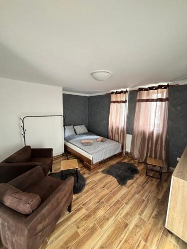a living room with a couch and a bed at Northern Panorama in Jílové