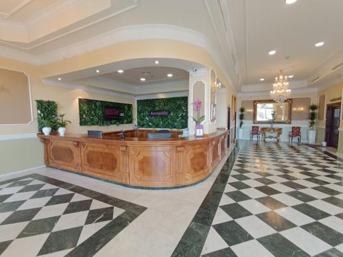 a lobby with a reception desk in a building at Hotel Bossh Alicia in Albacete