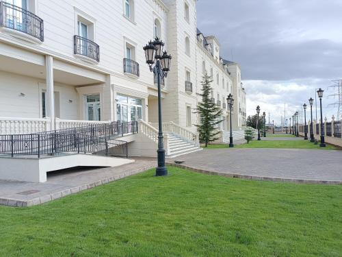 a street light in the grass in front of a building at Hotel Bossh Alicia in Albacete