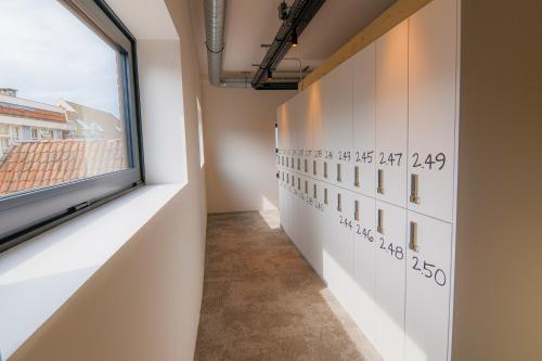 a hallway with a window and a wall with writing on it at PJs Hostel in Groningen