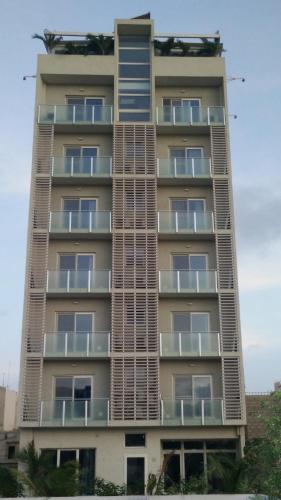 a tall building with balconies on the side of it at International Hotel Dakar in Dakar