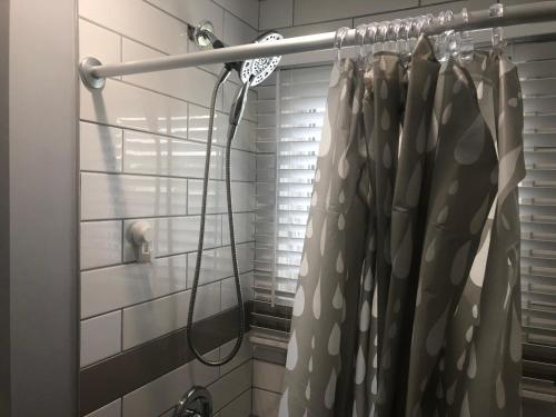 a shower curtain is hanging in a bathroom at Spotless 2 Bedrooms Suite 2 in Winnipeg in Winnipeg