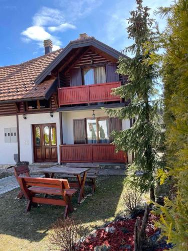 a house with a picnic table in front of it at Vila Malisevac in Mitrovac