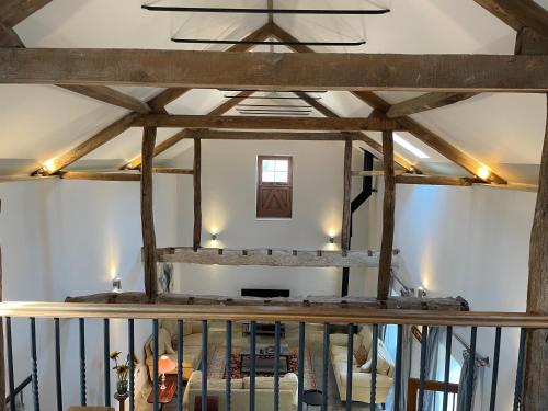 a room with a ceiling with wooden beams at The Carriage House, Haversham near Milton Keynes in Haversham