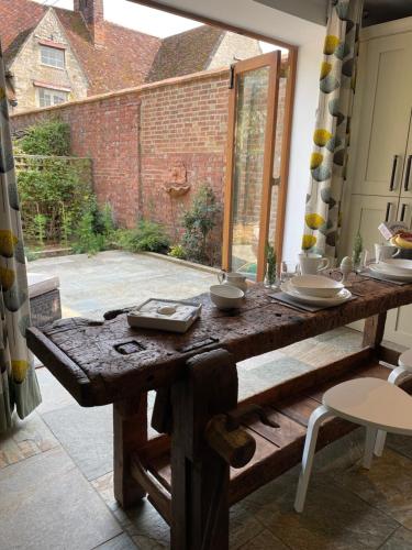a wooden table in a room with a large window at The Carriage House, Haversham near Milton Keynes in Haversham