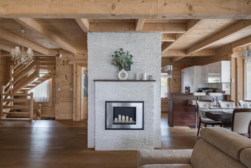 a living room with a fireplace in a house at Pienińska Przystań dom w Szczawnicy in Szczawnica