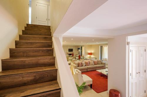 a staircase in a living room with a couch and a living room at Seafront Unit 1 in Cascais
