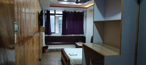 a small bathroom with a sink and a window at Hotel Assembly in Shillong