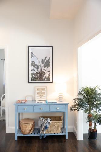 a blue console table with a picture on the wall at Halcyon Days your perfect getaway Sunday late check out, pet friendly! in Cessnock