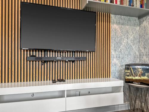 a flat screen tv hanging on a wall at Casa Ladrillo - House of Bricks in Calgary