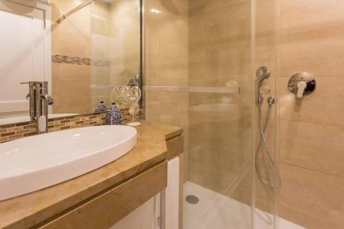 a bathroom with a sink and a shower at Cascais Panoramic Apartment in Cascais