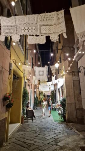 a couple of people walking down an alley with white clothes at My home in Sarzana in Sarzana