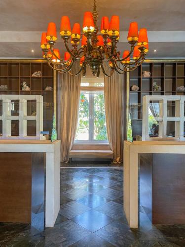 a chandelier in a room with a large window at Aquila Elounda Village Resort, Suites & Spa in Elounda