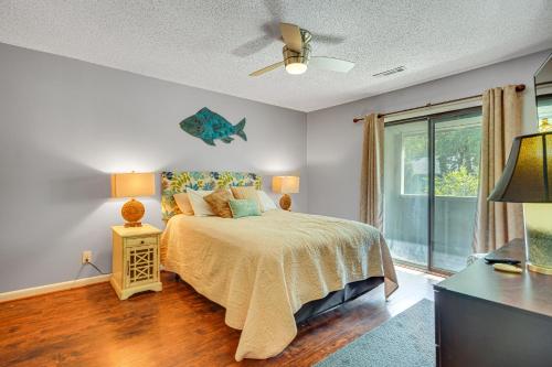 a bedroom with a bed and a large window at Mount Pleasant Condo - Near Charleston and Beaches! in Charleston