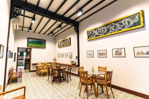 a dining room with wooden tables and chairs at ROSE - Fong Lee CC Lampang Walking Street in Lampang
