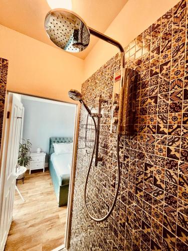 a bathroom with a shower with a mosaic wall at Ingleside Mews in Whitby
