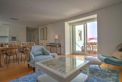a living room with a couch and a table at Urban Beach Estoril Apartment in Estoril