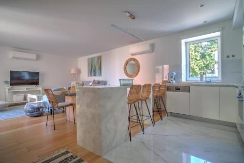 a kitchen with a bar and a living room at Urban Beach Estoril Apartment in Estoril