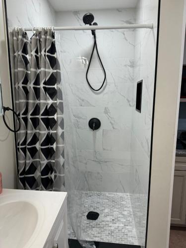 a shower with a glass door in a bathroom at Neverland in Jacksonville
