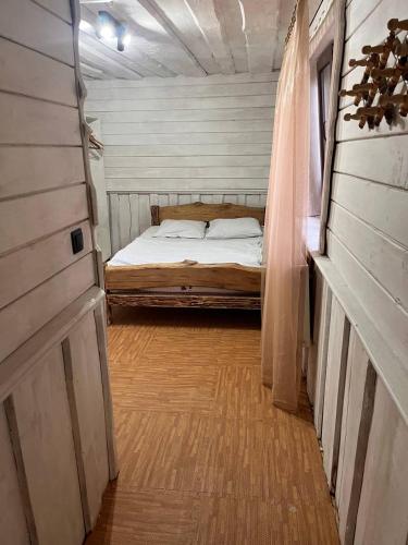 a bedroom with a bed in the middle of it at Готель Згарда in Dragobrat