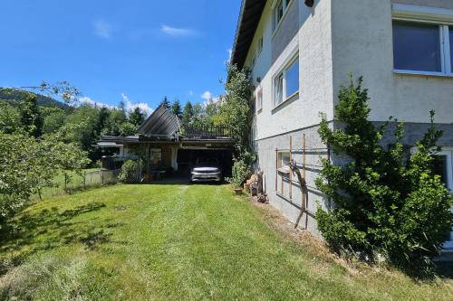 a car parked in a garage next to a house at Fewo Albeck in Spitzwiesen