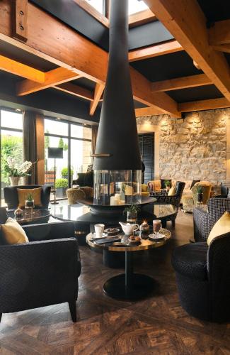 a large living room with couches and a fireplace at Domaine de la Klauss & Spa, Restaurant Gastronomique Le K in Montenach
