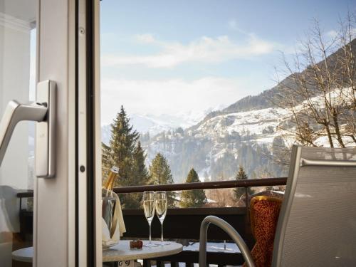 a balcony with a view of a snowy mountain at EUROPÄISCHER HOF Bad Gastein in Bad Gastein