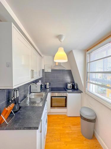 a kitchen with a sink and a counter top at Gower street residences in London