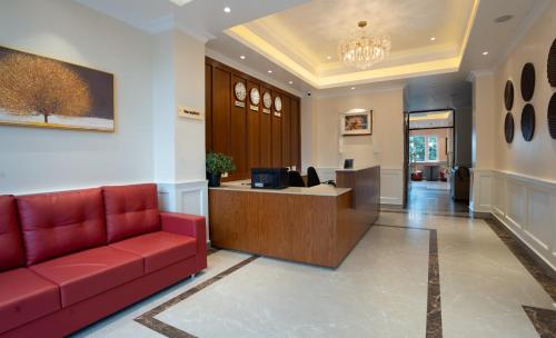 an office with a red couch in a lobby at Preisha Hotel and Resorts in Gangtok