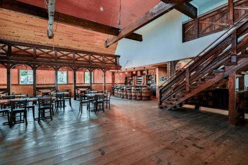 サンタンヌ・デ・モンにあるDomaine du Récifのテーブルと椅子、階段が備わる広い客室です。