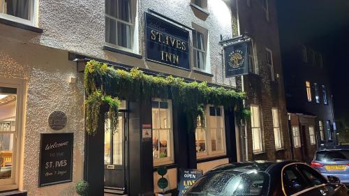 a building with a car parked in front of it at St Ives in Neath