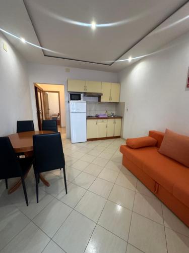 a living room with a couch and a table and a kitchen at Apartments Alać in Drasnice