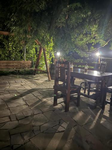 a table and two chairs on a stone patio at night at EleGaya Guest house in Ijevan