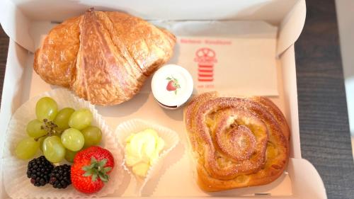 a box of food with bread and fruit on it at ipartment Wolfsburg in Wolfsburg