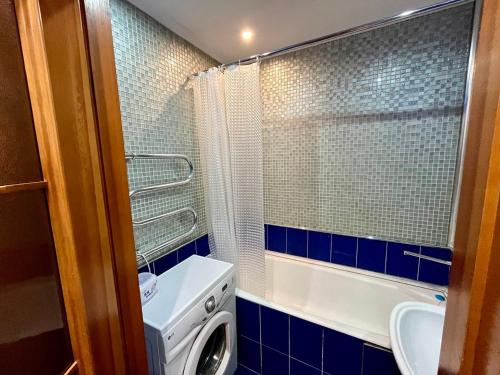 a bathroom with a washing machine and a sink at sairan comfort in Almaty