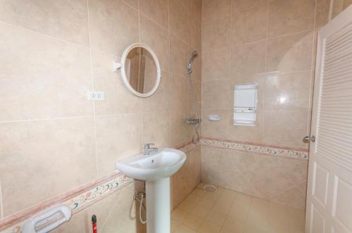 a bathroom with a sink and a shower at Peaceful Hua Hin Homestead in Hua Hin