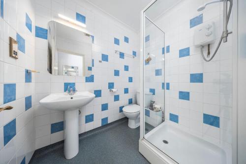 a bathroom with a sink and a toilet and a shower at The Grapes Pub in Southampton