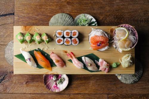 a plate of sushi on a wooden table at Snæfell - Hotel by Aldan in Seyðisfjörður