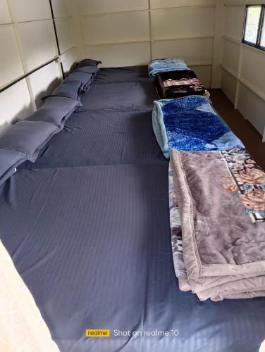 a group of beds sitting in a room at Hazy Mount Vattavada in Kottakamboor
