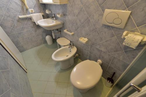 a small bathroom with a toilet and a sink at Eden Park Hotel in Marina di Campo