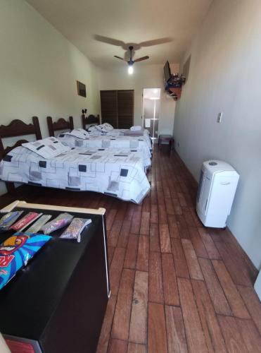 a room with two beds and a table in it at Café Palace Hotel in Três Pontas