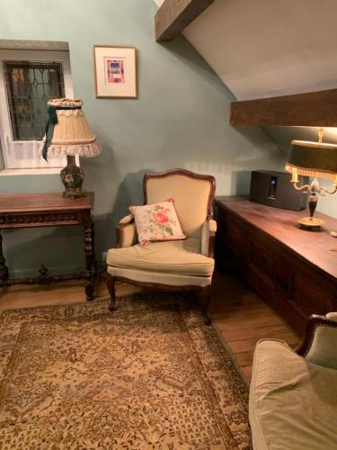 un salon avec une chaise et une table dans l'établissement Maison de campagne, à Saint-Étienne-de-Vicq