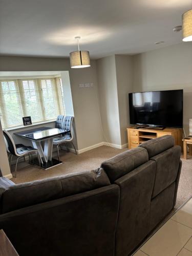 a living room with a couch and a table at Two Bedrooms Two Bathrooms and Private Parking Rugby in Rugby