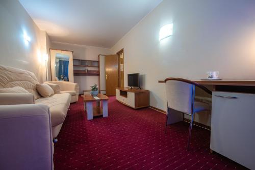 a living room with a couch and a table at Hotel Doina in Neptun
