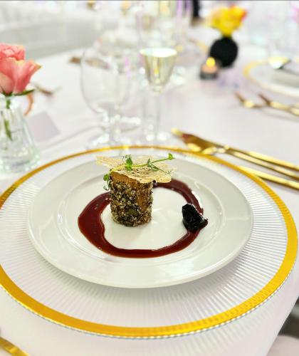 a white plate with a dessert on a table at Vegas Hriňová Penzión in Hriňová