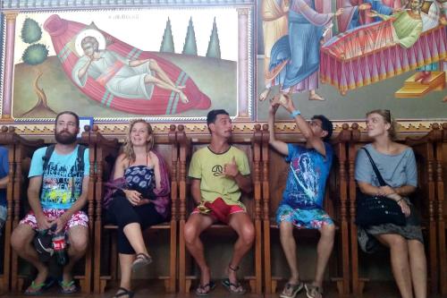 a group of people sitting in front of a painting at Tiberias Hostel in Tiberias