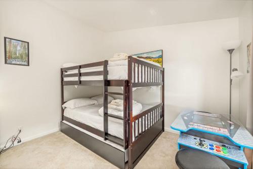 a bedroom with a bunk bed with white sheets at HIlltop Oasis with games, hot tub, Fire-pit, Deck, Views in Oakhurst