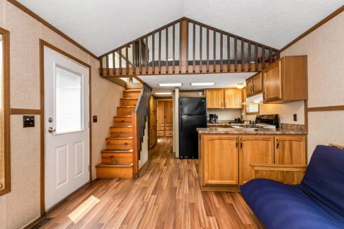 a kitchen with wooden cabinets and a spiral staircase at Jellystone Park Birchwood Acres in Greenfield Park