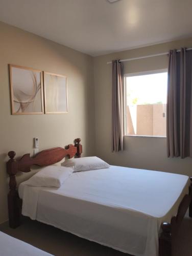 a bedroom with two beds and a window at Casa Jacuípe in Camaçari