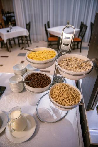 a table with several bowls of food on it at Hotel Doina in Neptun